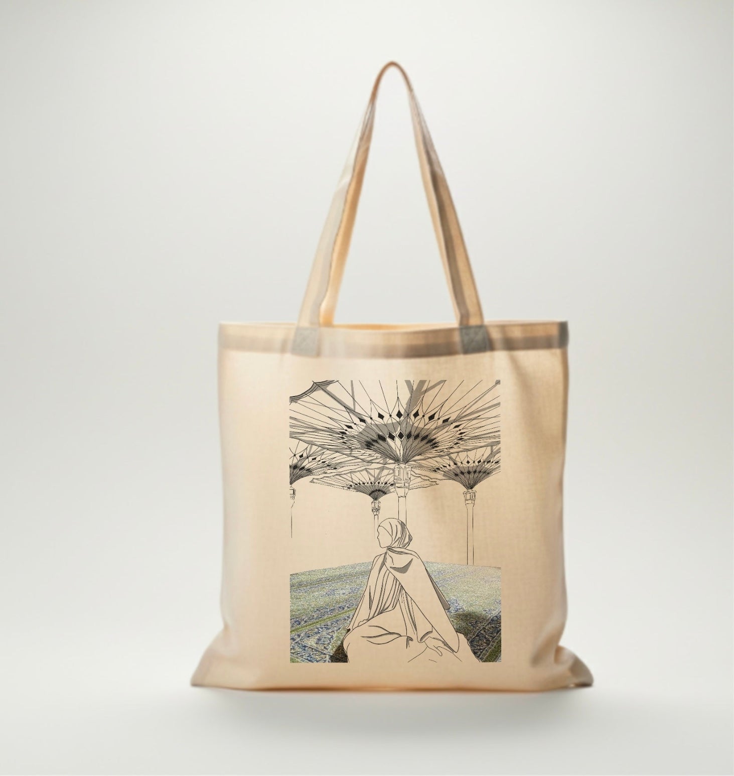 Sac fourre-tout beige avec dessin d’une femme voilée assise sous les célèbres ombrelles de la mosquée de Médine, ambiance spirituelle.